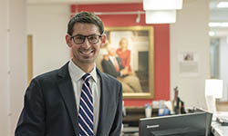 Dr. Evan Graboyes stands at a desk